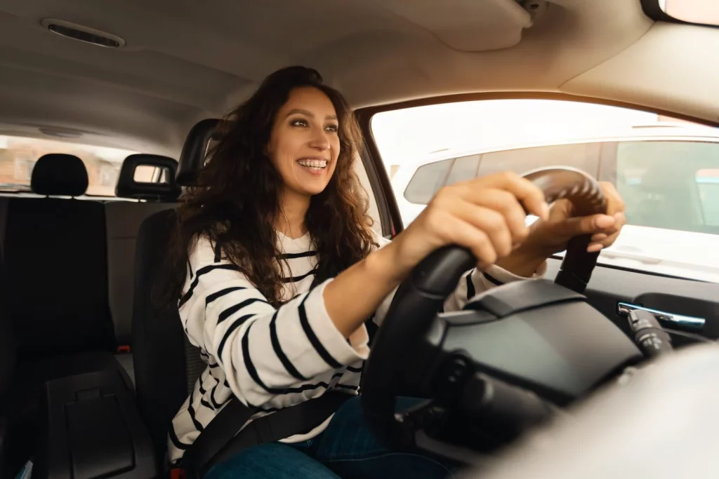 smiling female driving new car city Moncloa